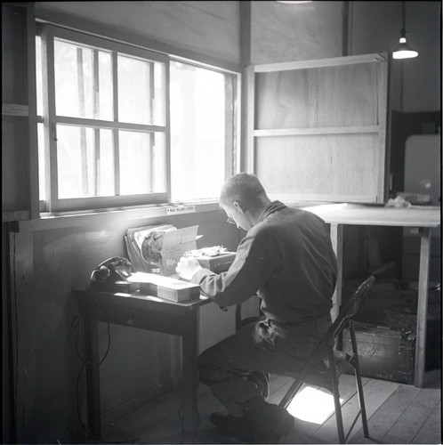 Warrant Officer at desk with typewriter
