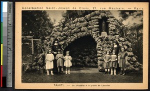 Missionary sisters and young girls pose at a grotto in Tahiti, French Polynesia, ca.1900-1930