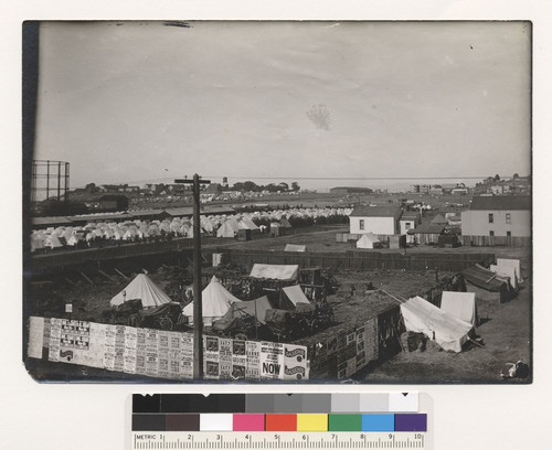 Refugee camp near Ft. Mason. Note gas tanks present. Army warehouse in background. Van Ness & No. Point Sts. Picture taken near Laguna. [Lobos Square refugee camp.]