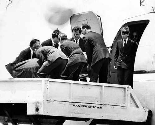 Taking Kennedy aboard plane