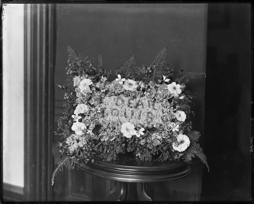 Floral arrangement on stand, by or for Louis France. [negative]