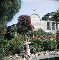 Slides of California Historical Sites. Unidentified mission with unidentified woman
