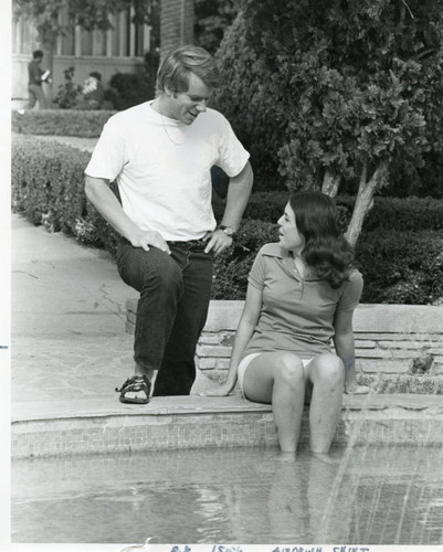 Students talking by central fountain of LA campus, circa 1970