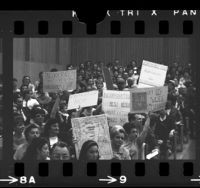 People holding up signs opposing annexation of Dominguez at Los Angeles County Local Agency Formation Commission meeting, Carson, 1967