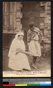 Nun tending a young woman's foot, Madagascar, ca.1920-1940