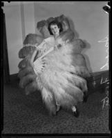 Sarah E. Foster shows off the fans she uses while dancing, Los Angeles, 1934
