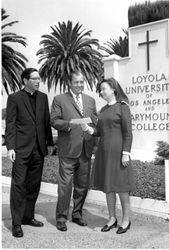 Donald Merrifield and Sister Raymounde McKay accepting check from Bob Prescott