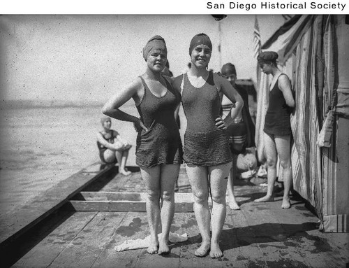 Grace Garner and Eleanor Kindberg in bathing suits on a pier