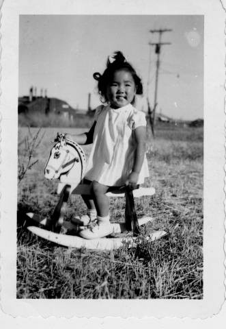 Little girl on rocking horse at Tule Lake Relocation Center [?]