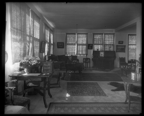 William Emerson Ritter sitting and reading in his apartment, which was the (top) second floor of the George H. Scripps Memorial Marine Biological Laboratory of the Marine Biological Association of San Diego (now Scripps Institution of Oceanography). November 7, 1909
