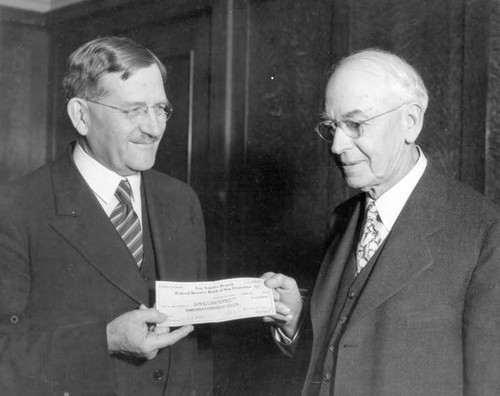 Mr. Scattergood (left) hand bond check to Lawrence McClelland Anderson