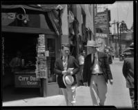 Roy Watkins, of the Angelus Temple, and Everett Davis walk down the street, 1932