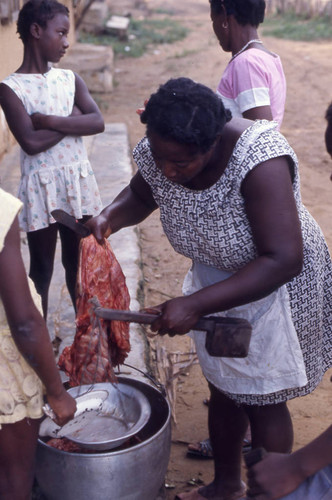 Woman weighing meat on scale, San Basilio de Palenque, 1976