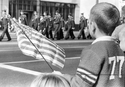 Youth greets military unit at Veterans Day parade
