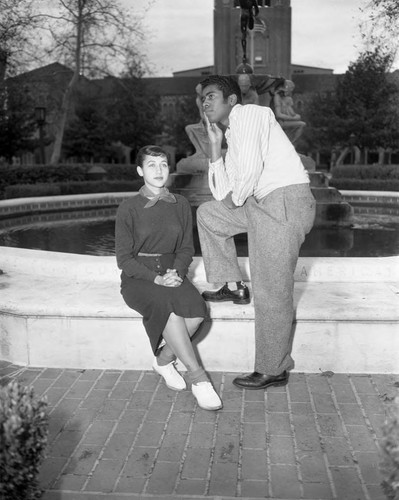 Couple posing in front of a water fountain, Los Angeles