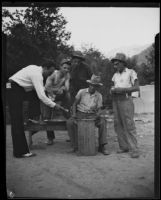 Gold miners Frank Robison, Charles T. Brown, and M.L. Sims selling gold, San Gabriel Canyon, 1932