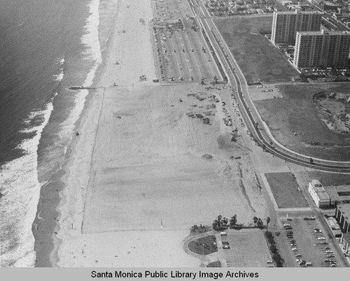 Looking north from the remains of the Pacific Ocean Park Pier to beach parking lots and Santa Monica Shores Apartments, August 13, 1975, 2:30 PM