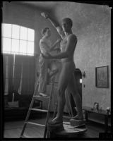 Nina Saemundsson working on her statue of Prometheus Bringing Fire to Earth in her studio, Los Angeles, 1934