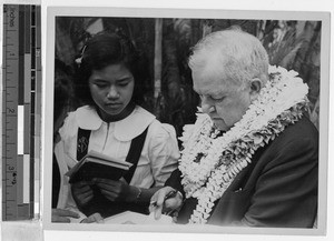 Bishop Boyle autographing a book, Honolulu, Hawaii, September 26, 1939