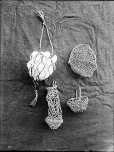 Four unidentified Indian woven items on display, ca.1900