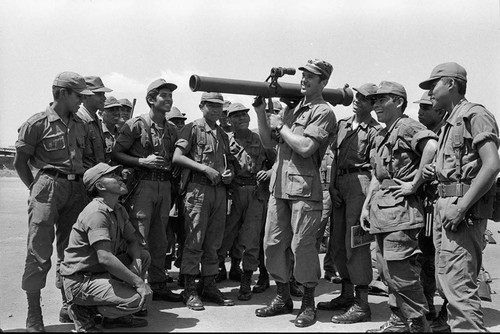U.S. military advisor training Salvadoran soldiers how to use mortars, Ilopango, 1983