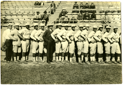 Group photograph of Pierce Giants Baseball Club with fans in background