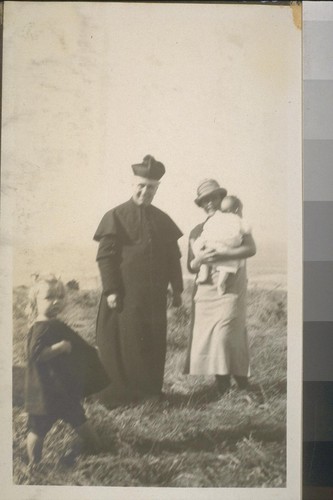 [Bishop? with woman and children]