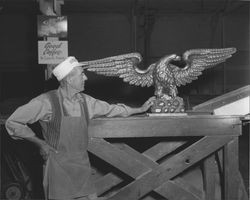 Lucien Pedeprade looks over the golden image of an eagle, Petaluma, California, about 1955