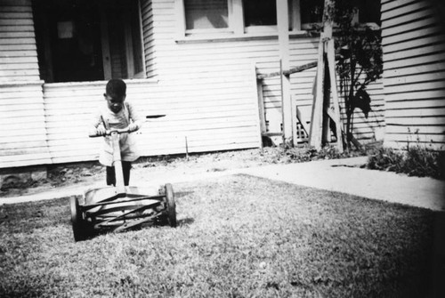 Young boy with a lawnmower