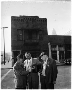 Model of restored fire station at Plaza and Los Angeles Street (standing in front of fire station), 1951