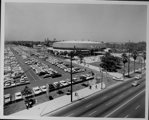 Exterior view of the Los Angeles Memorial Sports Arena with the parking lot in the foreground