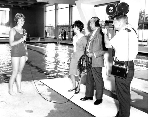 TV Crew Interviews Swimmer at Aquatorium