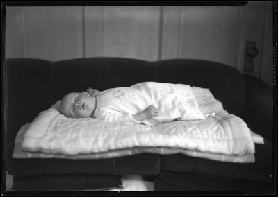 Portrait of baby lying on sofa
