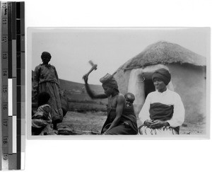 Woman chipping wood, South Africa East, 1929