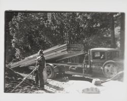 Truck delivering lumber for highway construction over the converted trestle between Guerneville and Guernewood Park, Guerneville, California, spring 1936