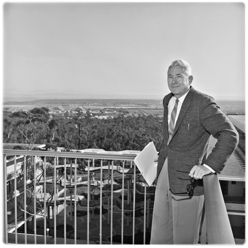 Chancellor John S. Galbraith on Urey Hall balcony with Camp Matthews in background, facing east