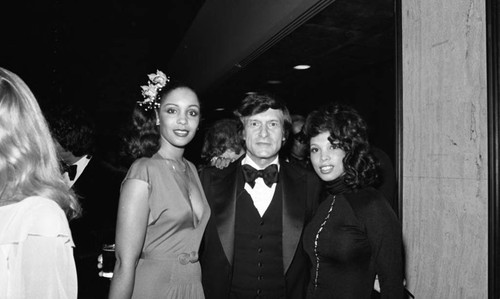Hugh Hefner posing with award presenters during the NAACP Image Awards, Los Angeles, 1978