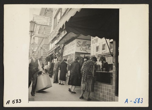 A close-out sale--prior to evacuation--at store operated by proprietor of Japanese ancestry on Grant Avenue in Chinatown. The evacuees of Japanese descent will be housed in War Relocation Authority centers for the duration. Photographer: Lange, Dorothea San Francisco, California