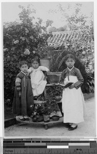 Three girls standing in a garden, Korea, ca. 1920-1940