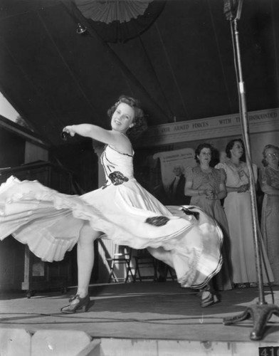 Young woman twirls as she dances