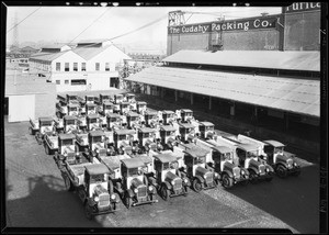 Fleet of cars and exterior of Cudahy Packing Co. buildings, Southern California, 1929