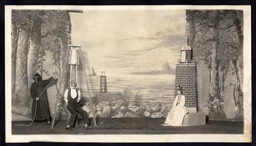 Man in Western dress is in danger of execution by hooded executioner, a woman sits on right, staged at the Great Star Theatre /