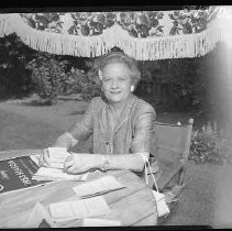 Unidentified woman seated at patio table