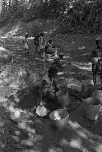 Girl collecting water at river, San Basilio de Palenque, ca. 1978