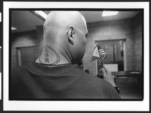 Man of Filipino origin with tattoo on back of his neck, holding American & Filipino flags, SOMA, San Francisco, California, 2002