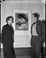 John Coleman Burroughs, standing next to his wife J.C. Coleman, exhibits oil paintings at Stendahl Gallery, Los Angeles, 1937