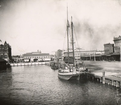 Stockton - Harbors - 1890s: View of channel with sailboat and courthouse