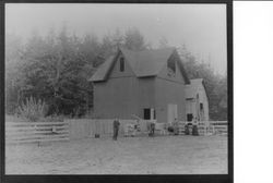 Unidentified family in front of their barn