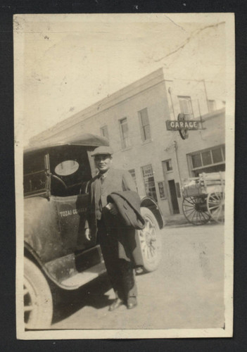Man standing next to a Tozai Company car