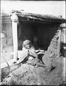 Old Mojave Indian woman sitting in a ramada, ca.1900